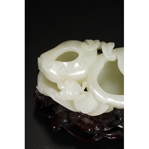 109 - A white jade 'lotus' brush washer, Qing Dynasty 13cm long, 7cm high (with stand), 5.5cm high (withou... 