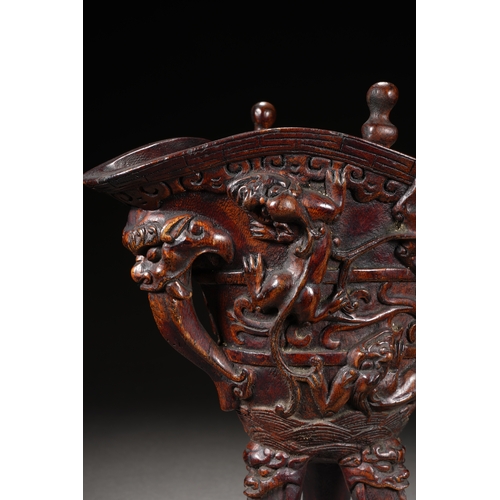 120 - A bamboo carved archaistic rhyton cup, Qing Dynasty 22cm high, 17cm long