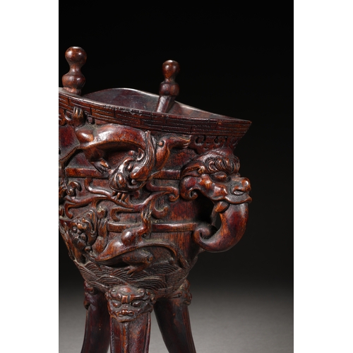 120 - A bamboo carved archaistic rhyton cup, Qing Dynasty 22cm high, 17cm long