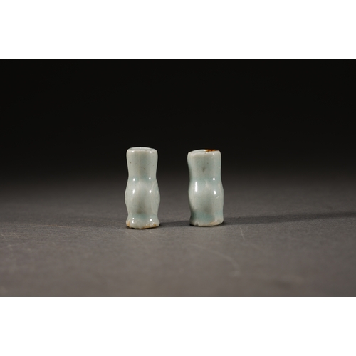 2 - A pair of celadon glazed incense stick holder the larger one 3cm high