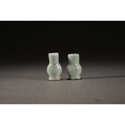 2 - A pair of celadon glazed incense stick holder the larger one 3cm high