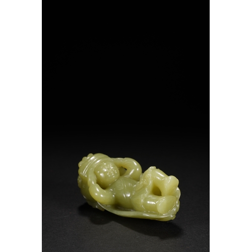 22 - A yellow jade carving 'boy in lion dance costume', Qing Dynasty 8.5cm high