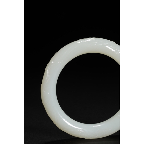 25 - A white jade 'bamboo' bangle, Qing Dynasty 7.9cm diameter