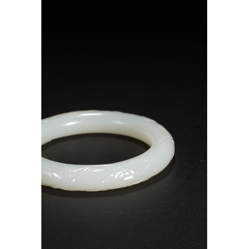 25 - A white jade 'bamboo' bangle, Qing Dynasty 7.9cm diameter