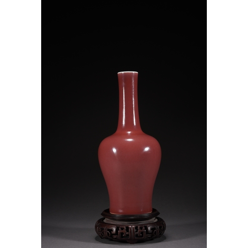 31 - A copper-red glazed vase with woodstand 23cm high, 10cm wide