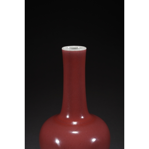 31 - A copper-red glazed vase with woodstand 23cm high, 10cm wide