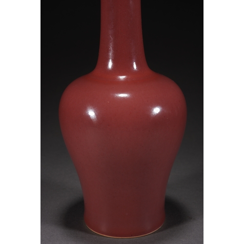 31 - A copper-red glazed vase with woodstand 23cm high, 10cm wide