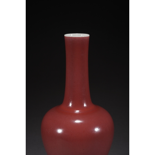 31 - A copper-red glazed vase with woodstand 23cm high, 10cm wide