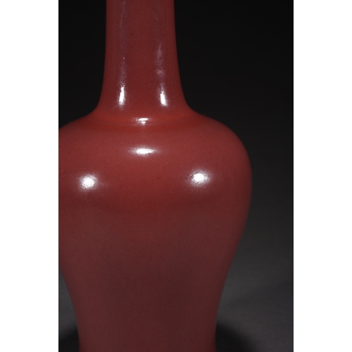 31 - A copper-red glazed vase with woodstand 23cm high, 10cm wide