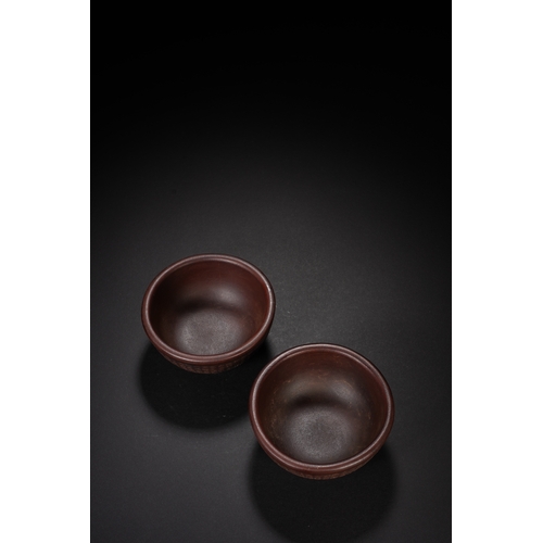 44 - A pair of incised zisha tea cup 8.5cm diameter, 4cm high