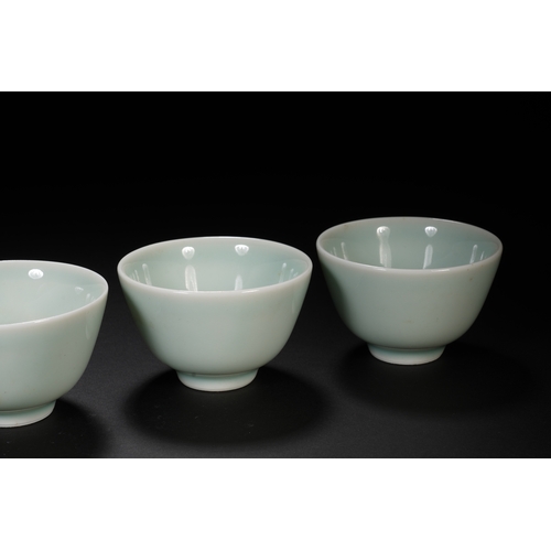 68 - A group of four celadon glazed tea cups the largest one 7.5cm diameter, 5cm high