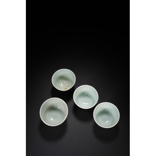 68 - A group of four celadon glazed tea cups the largest one 7.5cm diameter, 5cm high