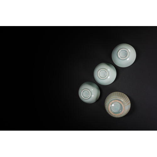 68 - A group of four celadon glazed tea cups the largest one 7.5cm diameter, 5cm high