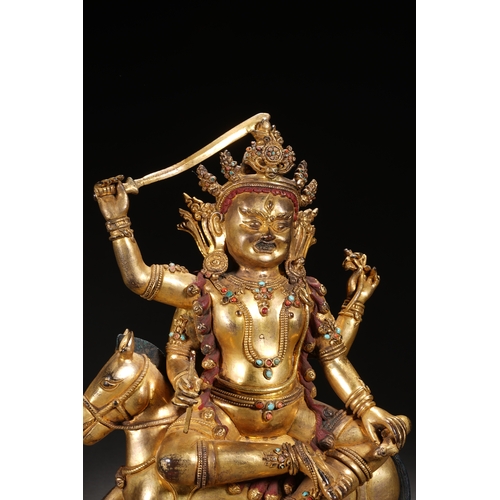 82 - A gilt bronze seated status of the four-armed Dharma King, Qing Dynasty 24.5cm high, 21cm wide... 