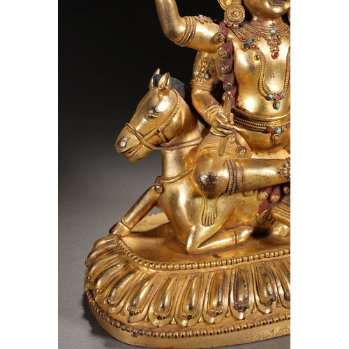 82 - A gilt bronze seated status of the four-armed Dharma King, Qing Dynasty 24.5cm high, 21cm wide... 