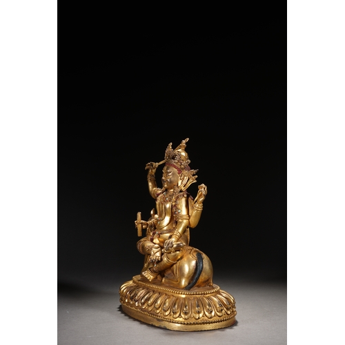 82 - A gilt bronze seated status of the four-armed Dharma King, Qing Dynasty 24.5cm high, 21cm wide... 