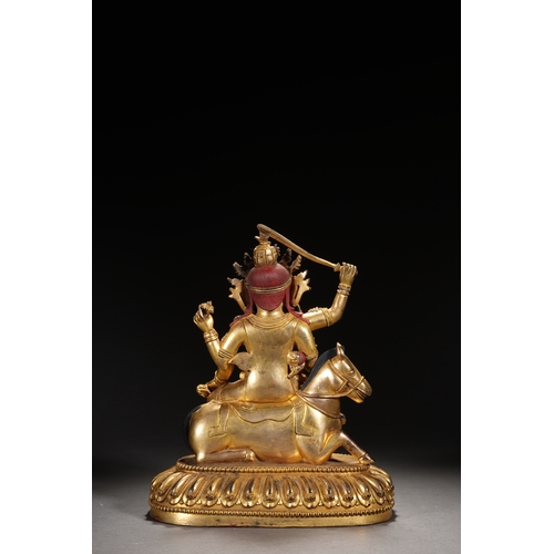 82 - A gilt bronze seated status of the four-armed Dharma King, Qing Dynasty 24.5cm high, 21cm wide... 