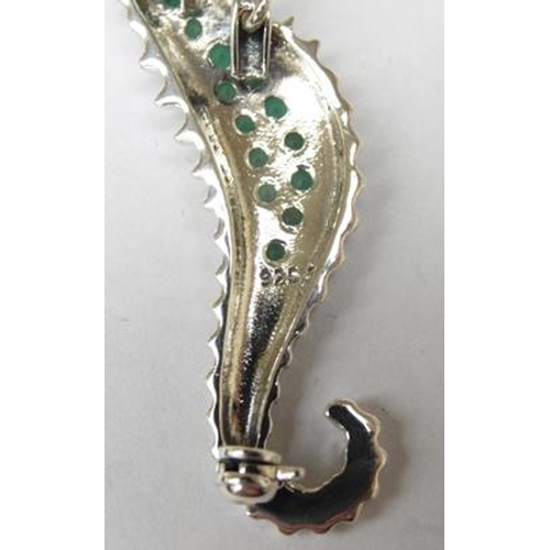 269 - Silver seahorse brooch with ruby eye emerald body