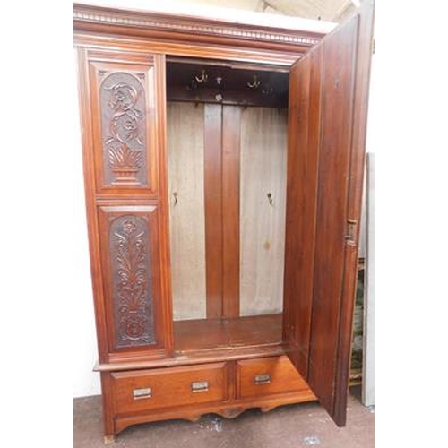 585 - Large oak carved design wardrobe with mirrored front, approx. 54 x 83 inches