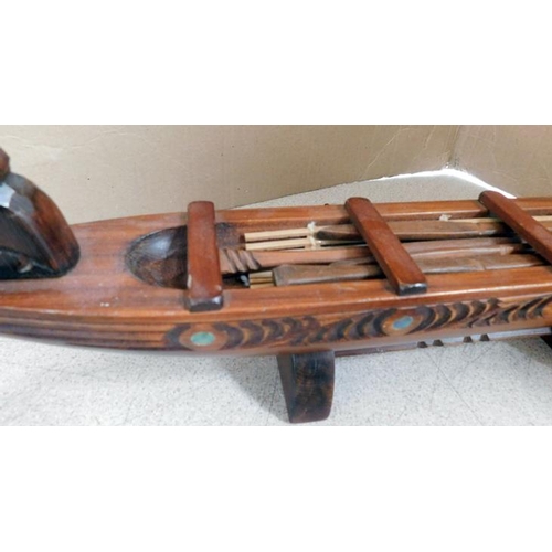72 - Pair of hand carved rhinos & boat