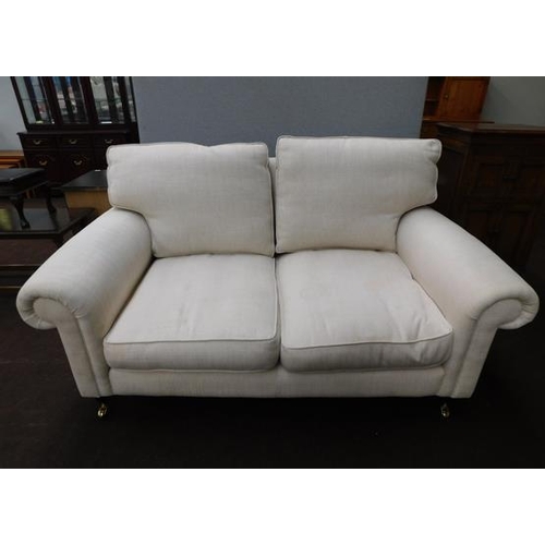 662 - Two seater settee with brass castors