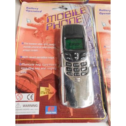 704 - Box of toy battery operated mobile phones