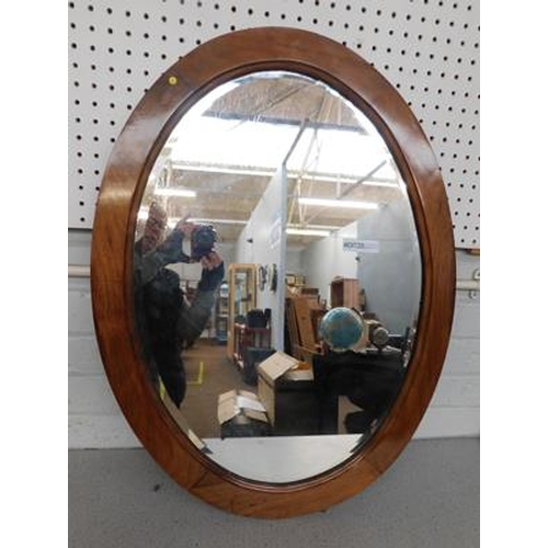 177 - Large oval bevel edged mirror in oak casing, approx. 31 inches tall