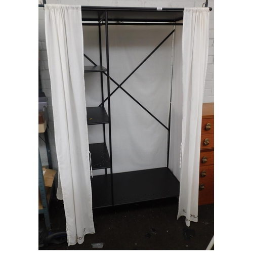 539 - Metal framed curtained wardrobe