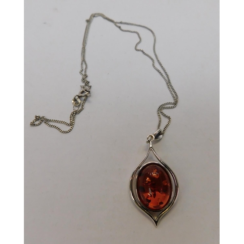 106 - Silver and amber pendant on silver chain