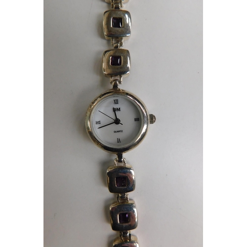150 - Sterling silver ladies watch, with mother of pearl face and amethyst detail