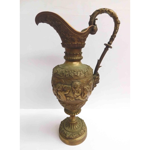 27 - Antique style - brass reticulated Bacchus Jug - featuring vines, cherubs & Faun head handle - 8kg, 1...