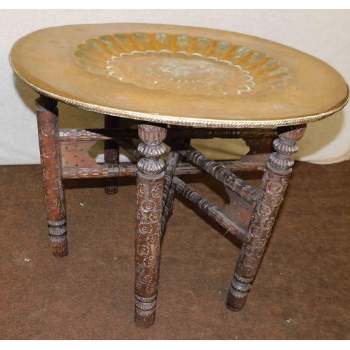 775A - Vintage brass charger topped occasional table with carved folding base