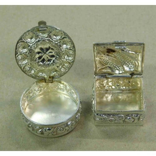 255 - Two - Indian silver - repousse decorated - snuff/pill boxes