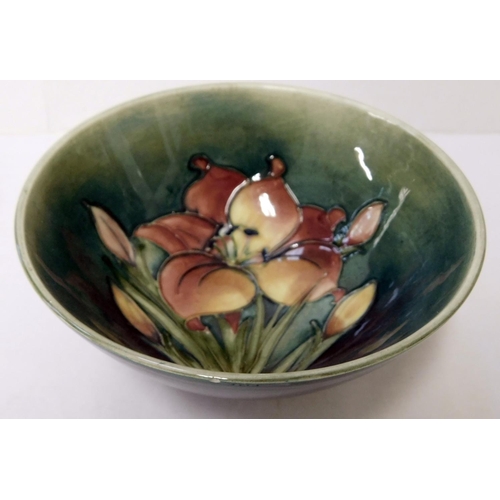 101 - Moorcroft - Spring flowers on green ground footed bowl - height 7cm - tiny chip to rim