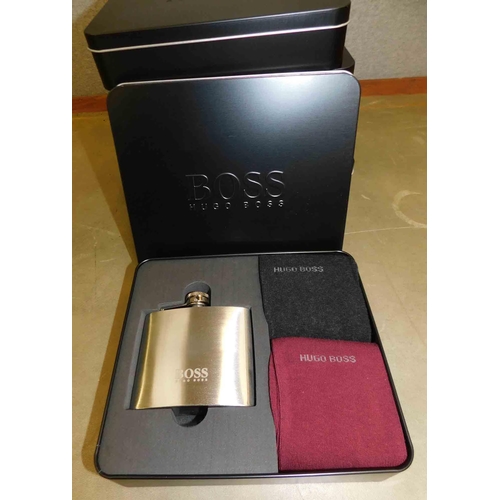 581 - 6x Hugo Boss presentation tins - each contains hip flask and 2x pairs of socks