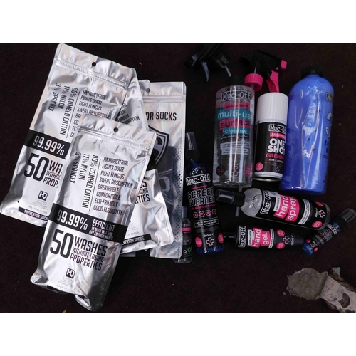 573 - Mixed box of Muc Off products incl. hand gel, sock protectors etc.