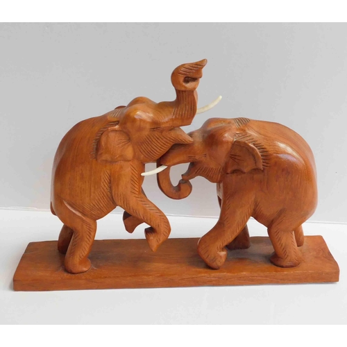 234 - Carved wooden elephants