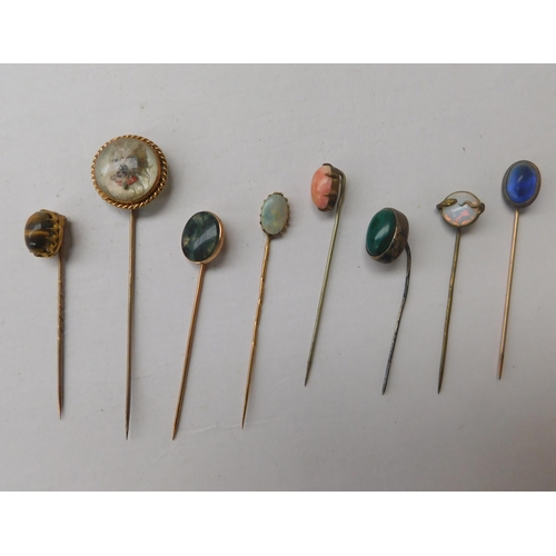 142 - Antique hat/sash pins including - semi precious stone set & gold examples - in antique pin cushion