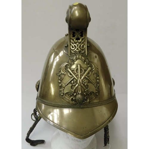 29 - Antique - brass Fireman's helmet - decorated with embossed dragons & crest - with leather liner