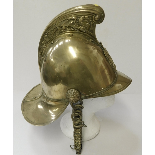 29 - Antique - brass Fireman's helmet - decorated with embossed dragons & crest - with leather liner...