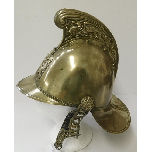 29 - Antique - brass Fireman's helmet - decorated with embossed dragons & crest - with leather liner...