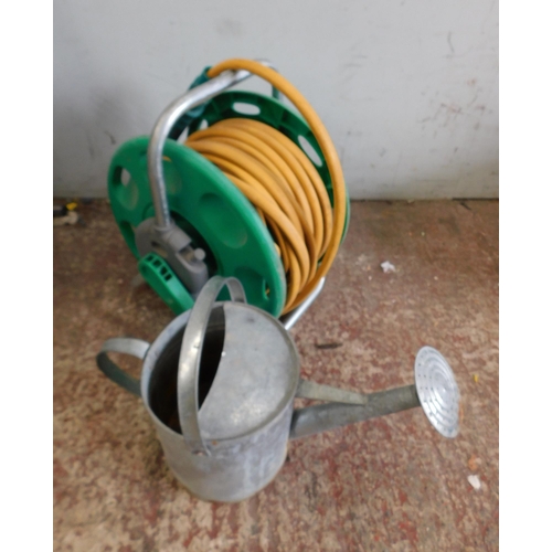 512 - Hosepipe on reel and galvanised watering can