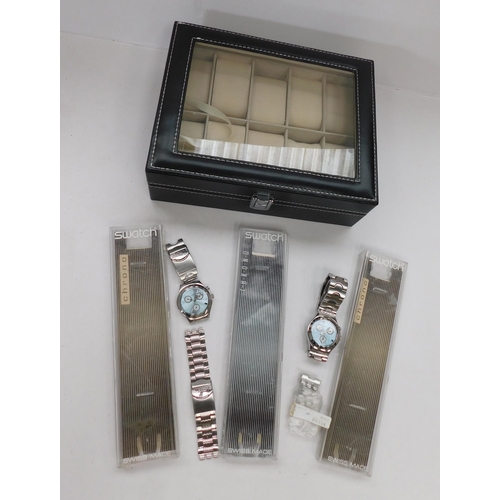 142A - Two - Gentleman's Swatch wristwatches - spares & repairs - & leather/watch display case - & three Sw... 