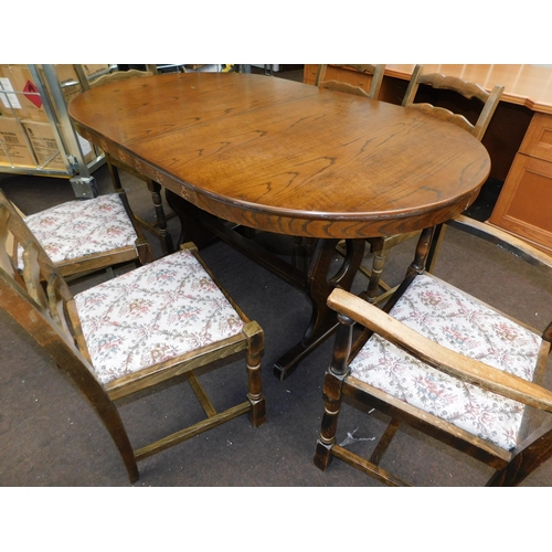 553 - Oval oak extending dining table and 6 chairs - 1 chair require attention