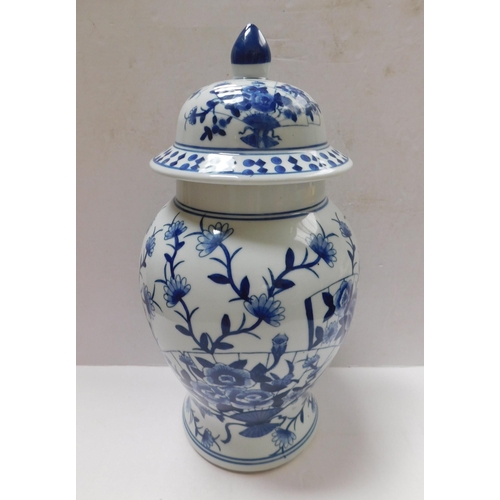 26A - Blue & white - floral decorated/lidded vase - height 17.5