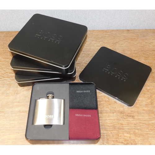 602 - Four Hugo Boss hip flask and sock gift sets in tins