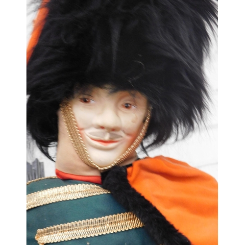 667 - Seated nursery rhyme style Queens Guard doll - app 30