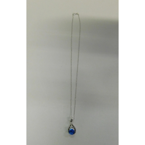 114 - Silver - blue topaz & marcasite pendant on silver chain