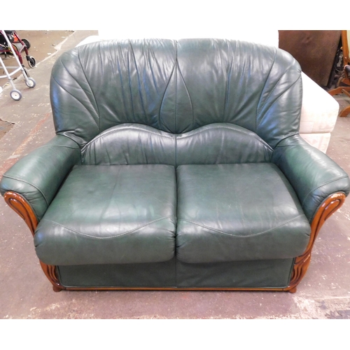 560 - Green leather two seater sofa