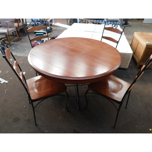 565 - Wrought iron dining table and four chairs